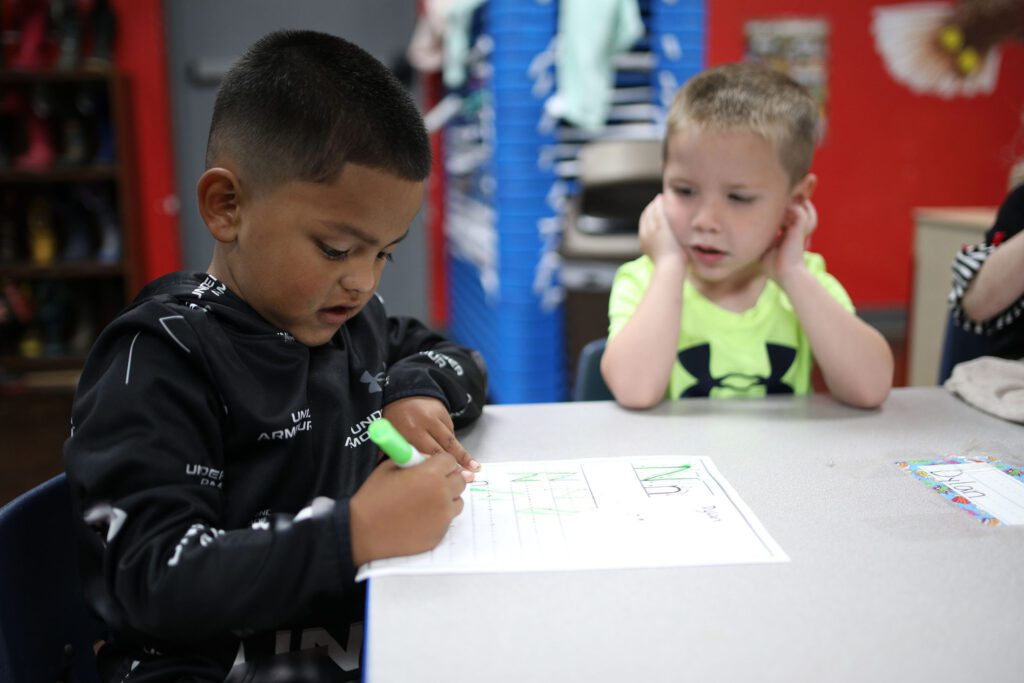 Child writing on worksheet